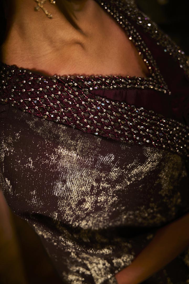 Ruched knot dress with a gold crushed foil cape