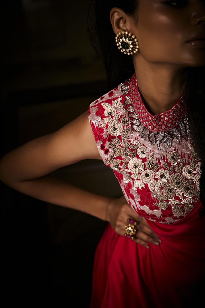 A sangria silk satin pre-draped saree paired with an intricately embroidered blouse.
