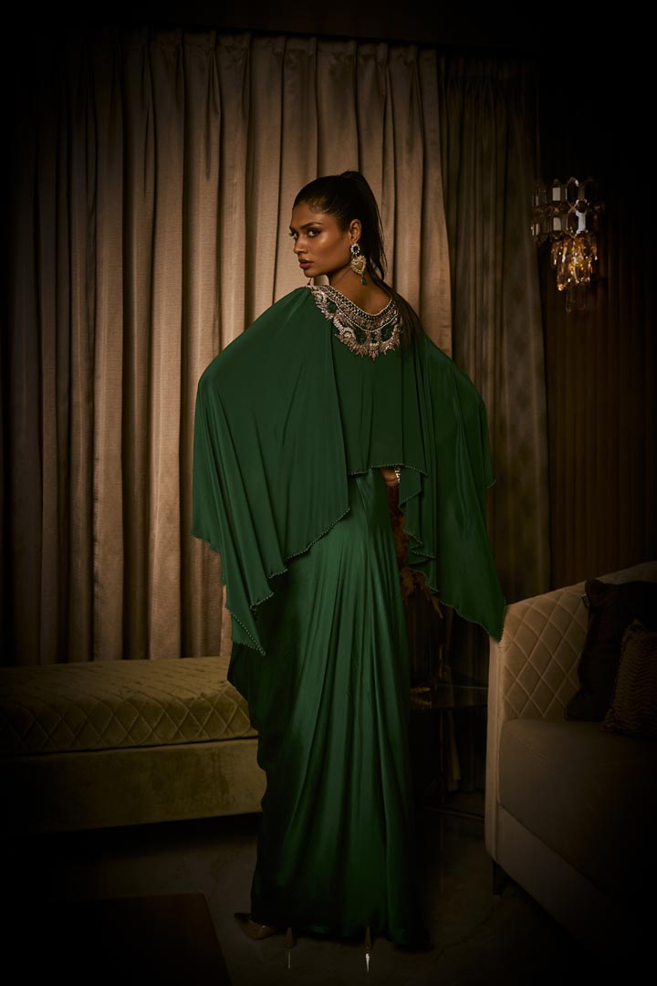 An emerald green pure silk satin dress with an attached cape and intricate beaded neckline.