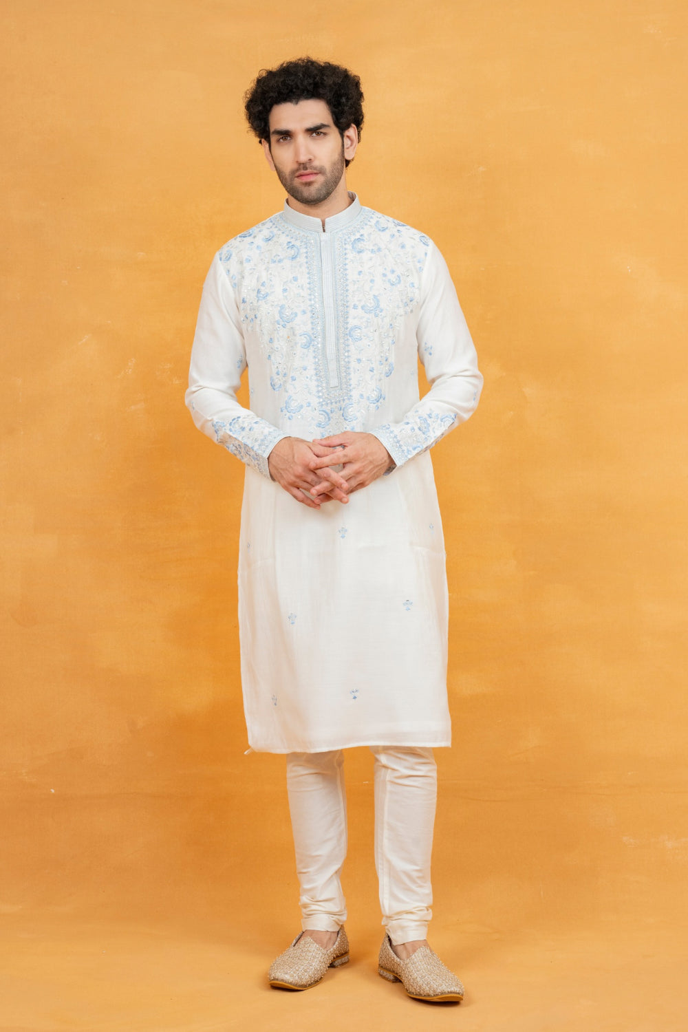 Cream silk kurta set with blue resham embroidery and mirror work