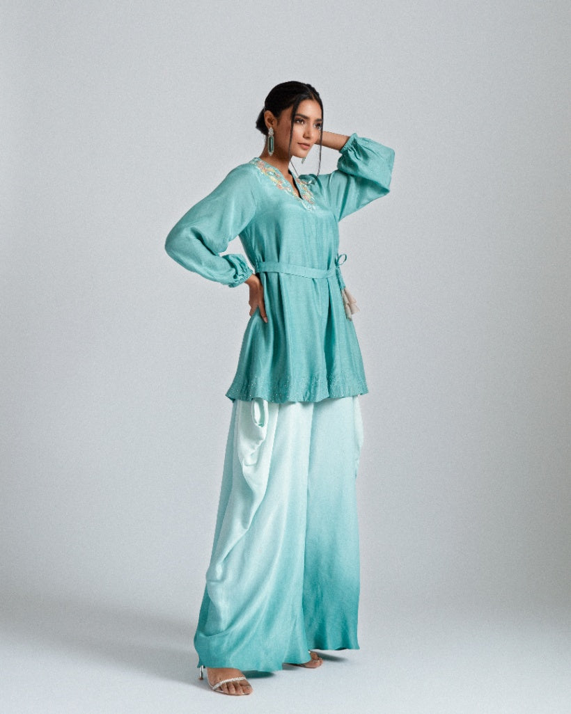 Aqua ombre silk mul mul tunic jacket with a belt and paired fusion dhoti drape trousers. 