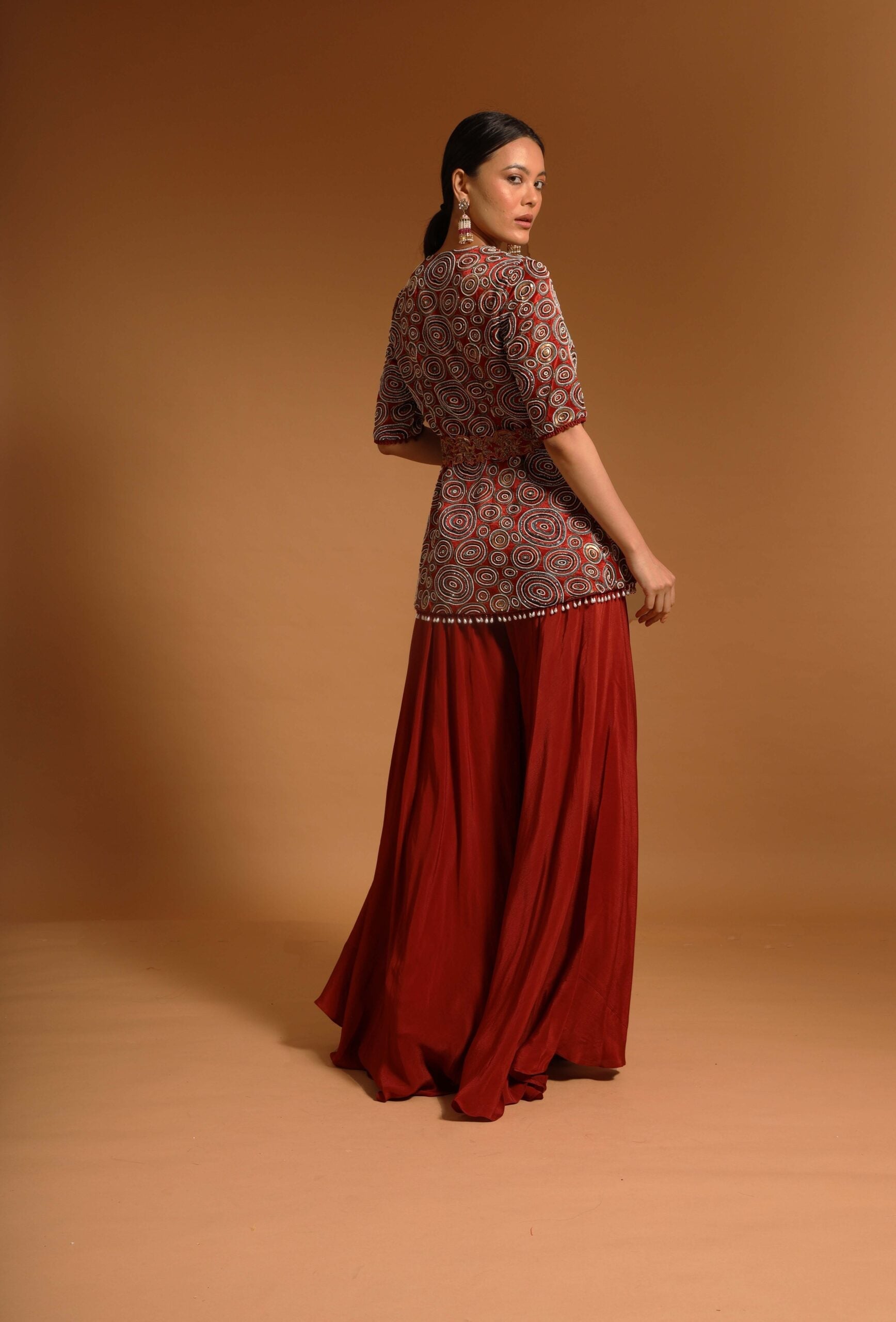 Red embroidered ajarkh peplum top with flare pants and embroidered waistbelt