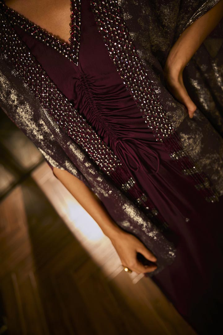 Ruched knot dress with a gold crushed foil cape