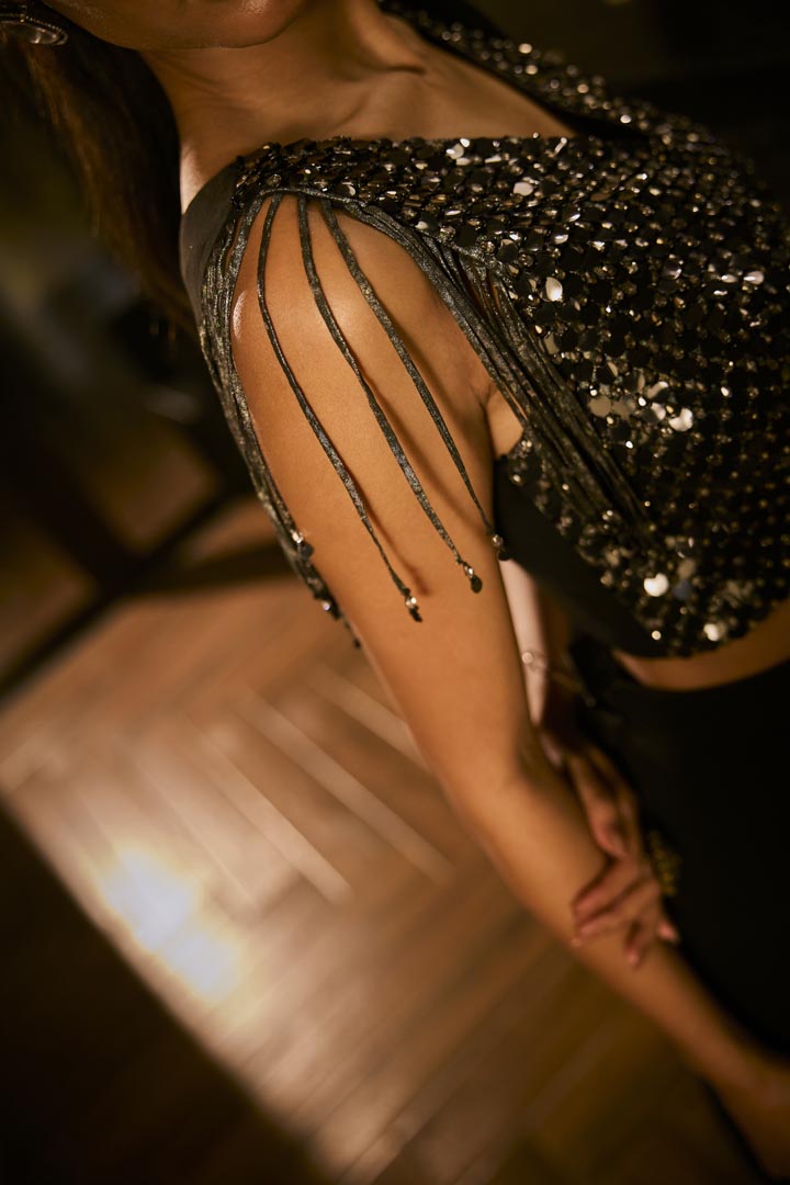 Black drape saree paired with a sequined blouse.