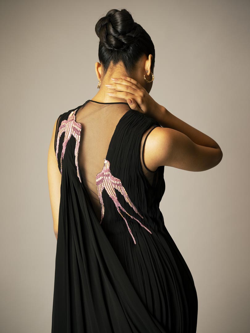 Black drape saree gown with pink 
embellished detailing and sheer neckline.Â”