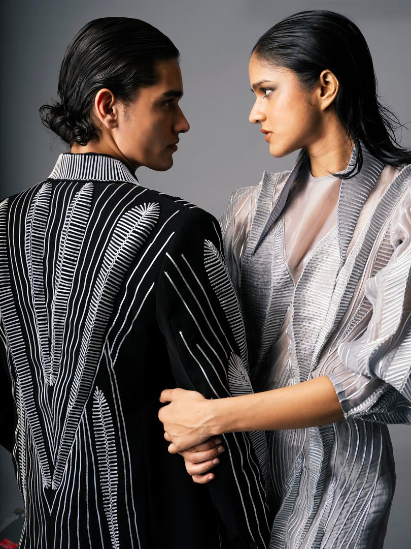 Silver embellished gown with
 sheer detailing and dramatic puff sleeve