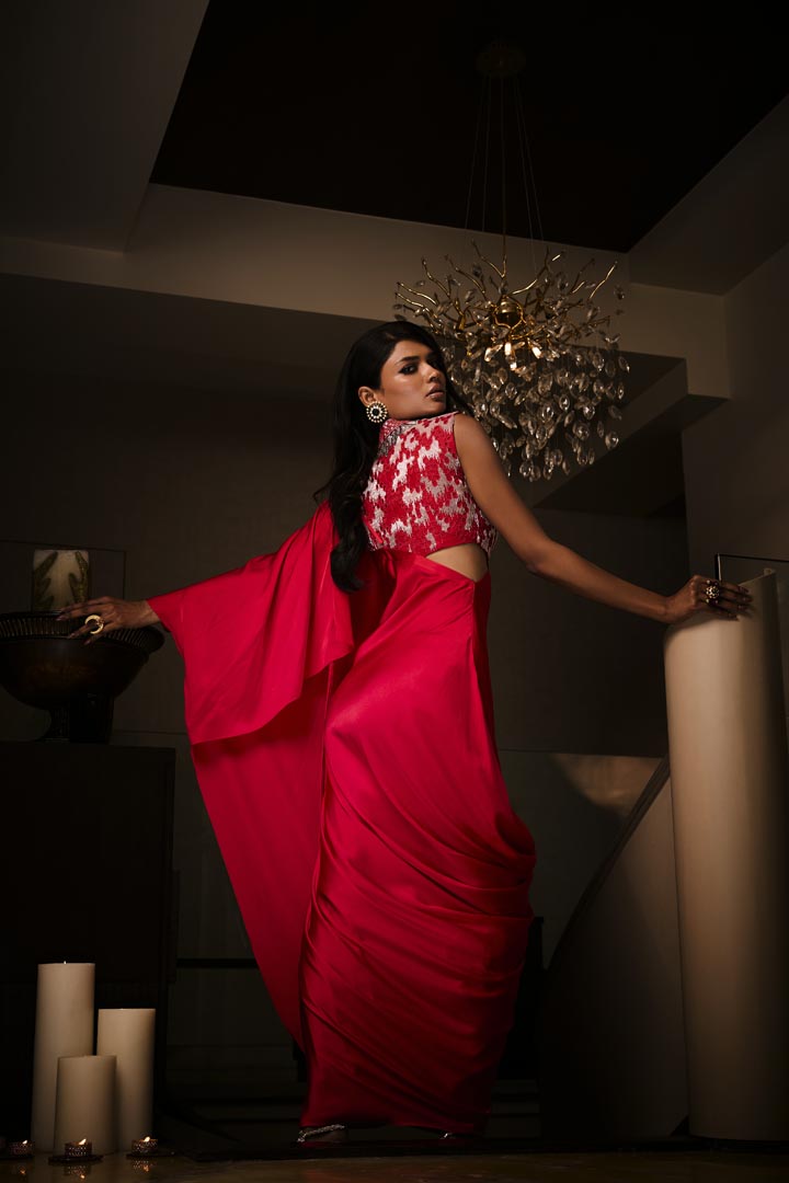 A sangria silk satin pre-draped saree paired with an intricately embroidered blouse.