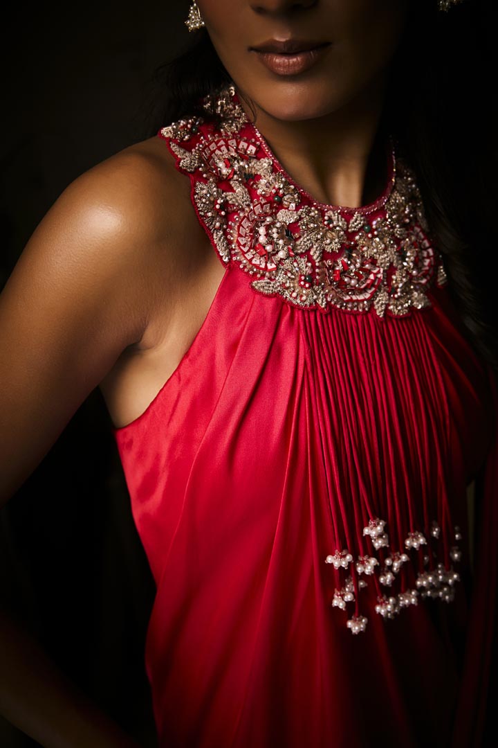 A sangria silk satin pre-draped saree gown with intricate neckline embroidery.
