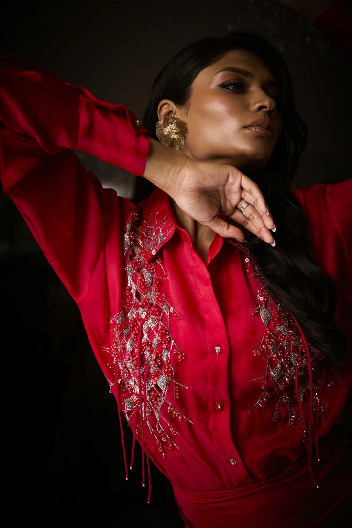 A sangria silk satin cowl skirt paired with an organza shirt, delicately hand-embroidered with sequins and beads.