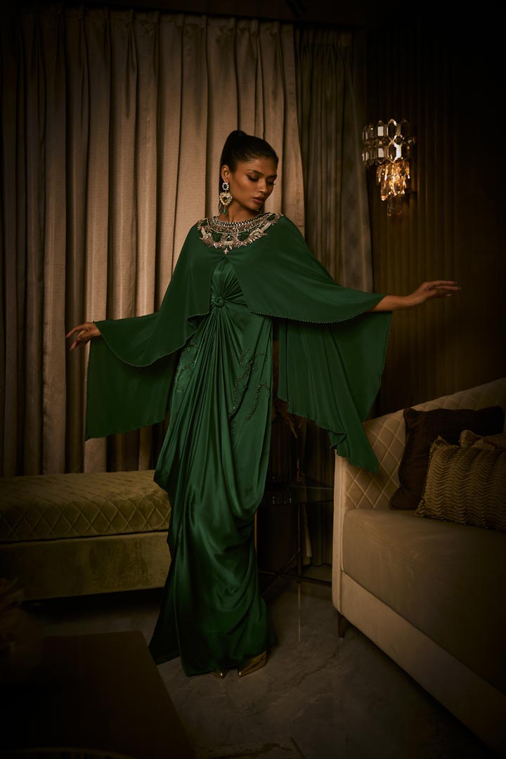 An emerald green pure silk satin dress with an attached cape and intricate beaded neckline.