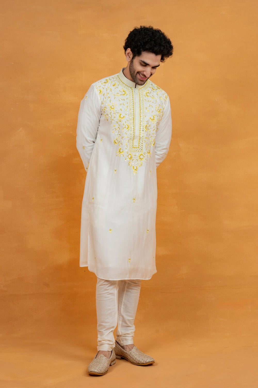 Cream silk kurta set with yellow resham embroidery and mirror work