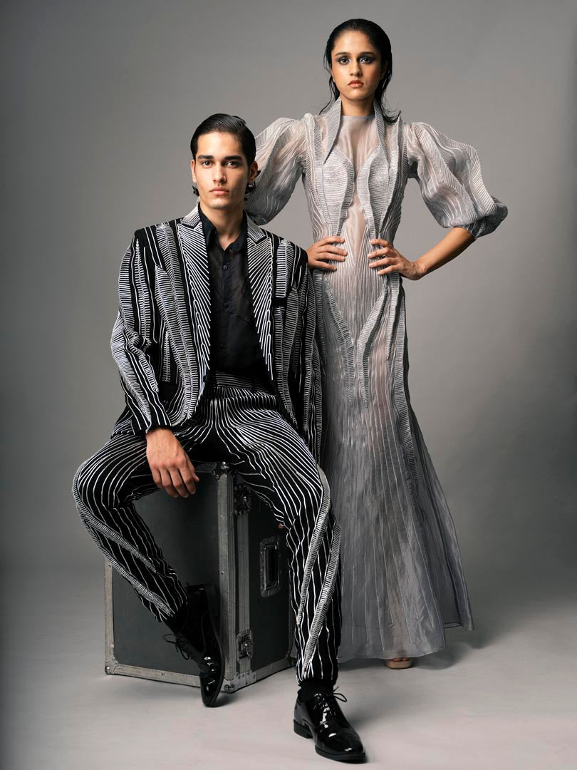 Silver embellished gown with
 sheer detailing and dramatic puff sleeve