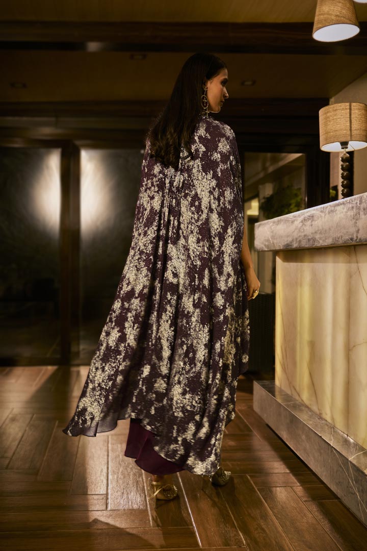 Ruched knot dress with a gold crushed foil cape