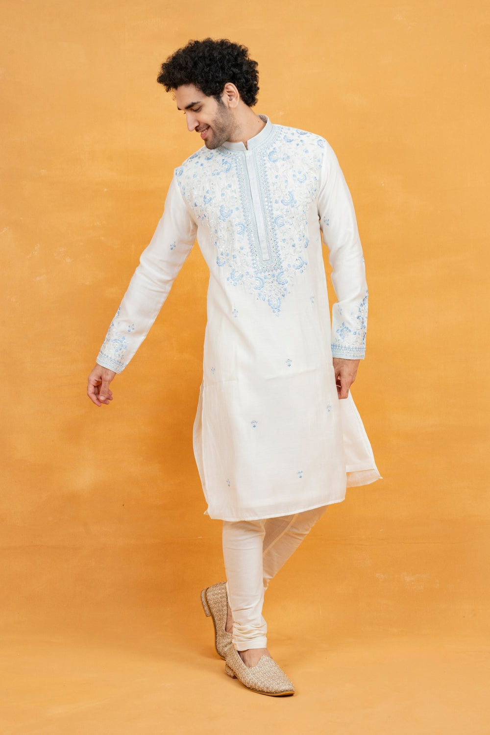 Cream silk kurta set with blue resham embroidery and mirror work