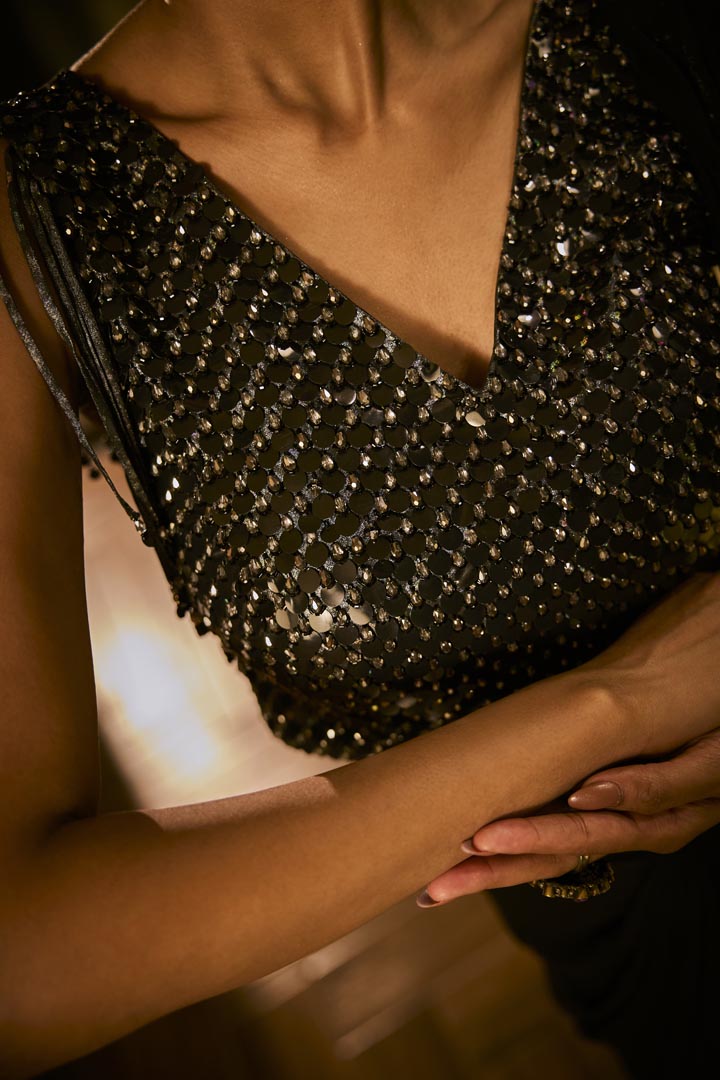 Black drape saree paired with a sequined blouse.