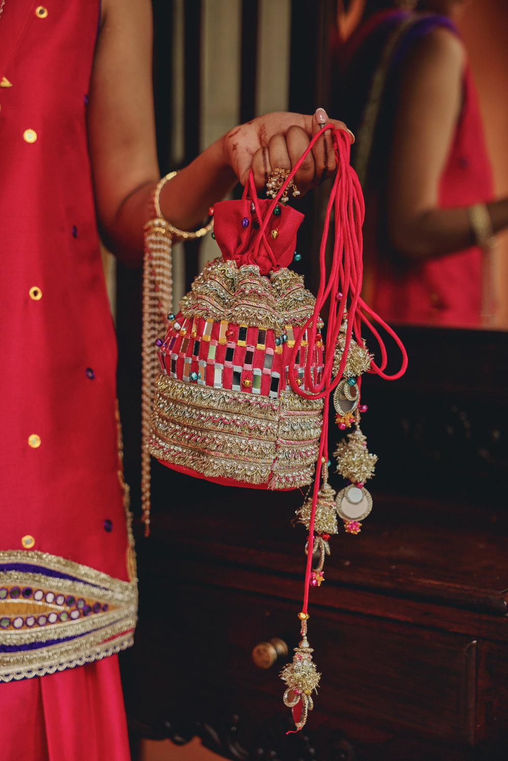 Rani Pink Embellished Potli Bag with Mirror Work and Tassels
