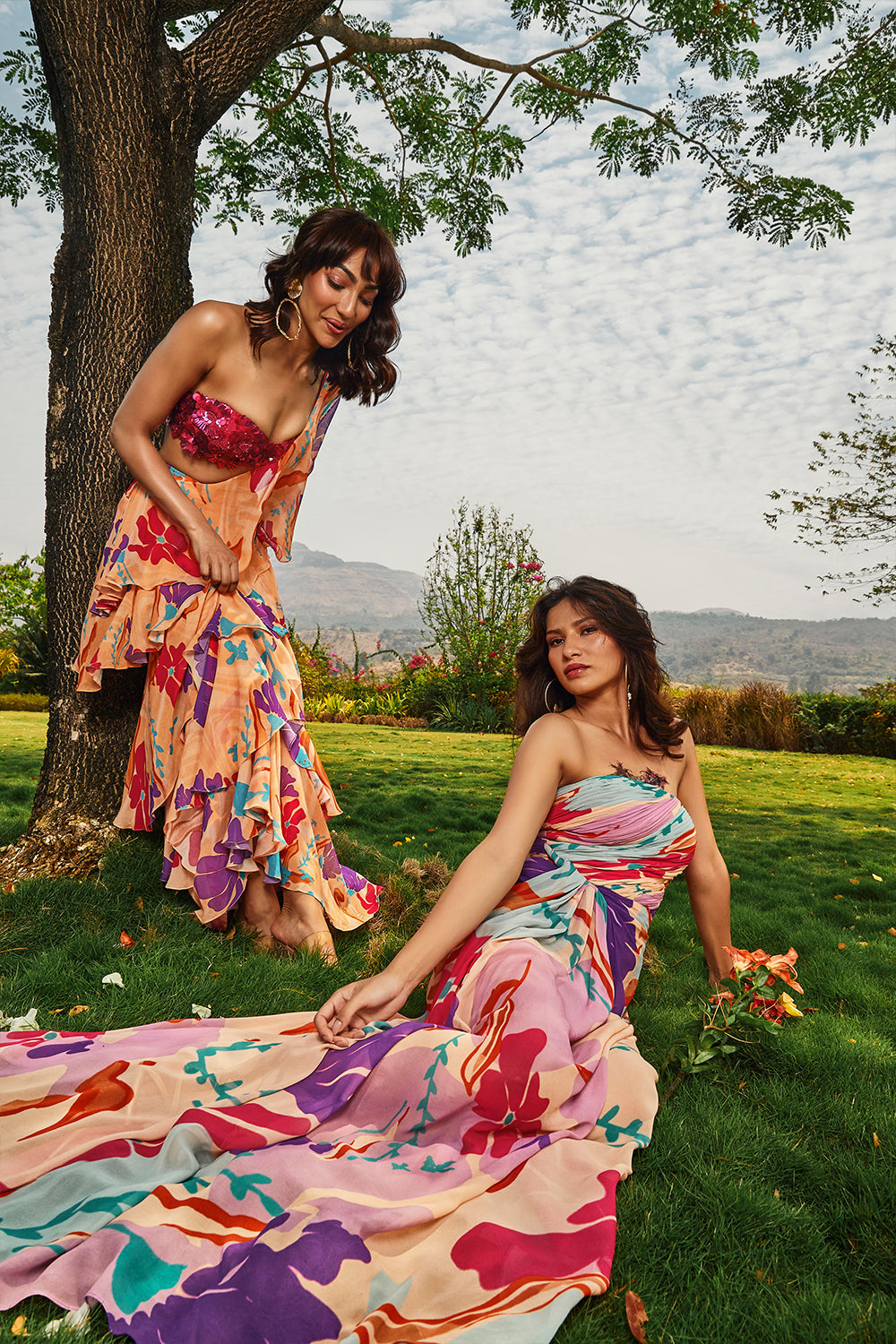 Cerise pink embellished bralette paired with floral printed ruffle saree.