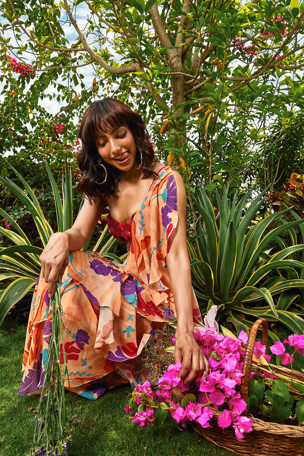 Cerise pink embellished bralette paired with floral printed ruffle saree.