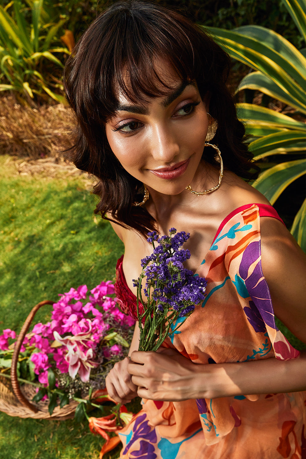 Cerise pink embellished bralette paired with floral printed ruffle saree.