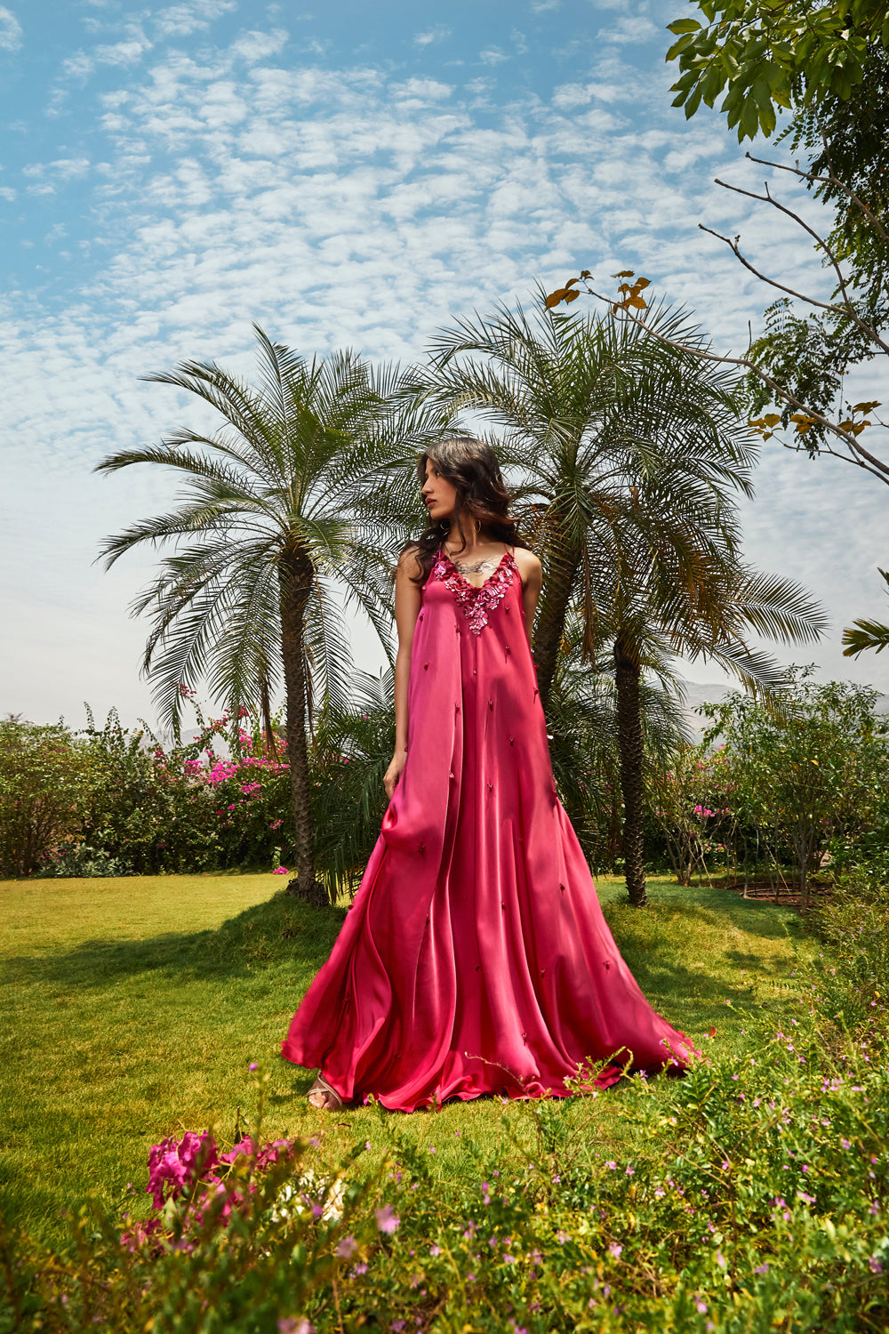 Foral printed cape paired with cerise pink bias dress.