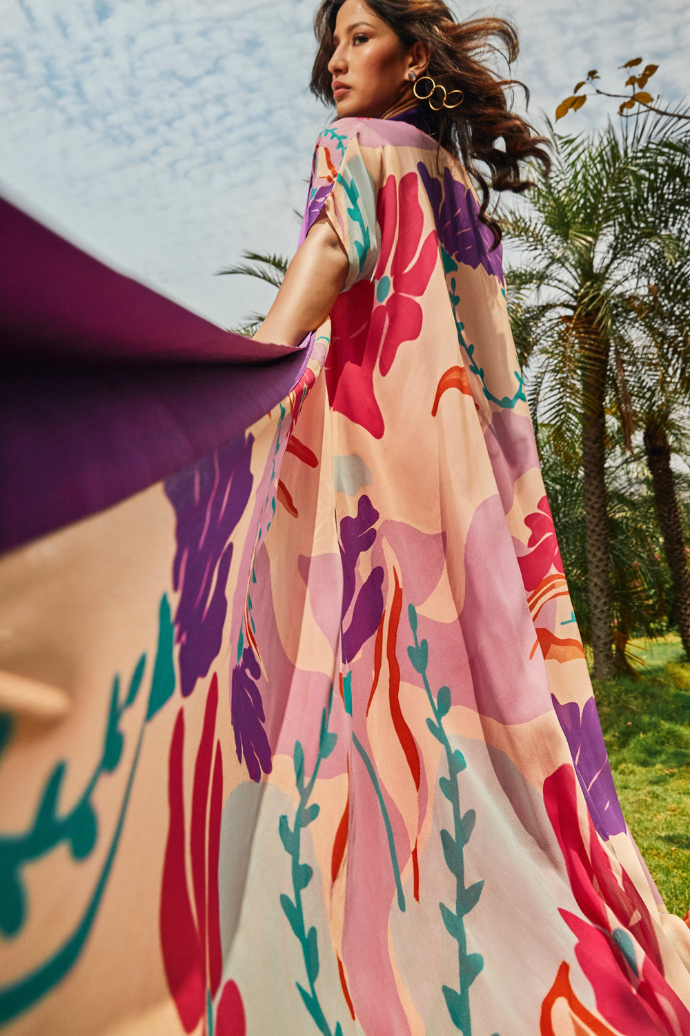 Foral printed cape paired with cerise pink bias dress.