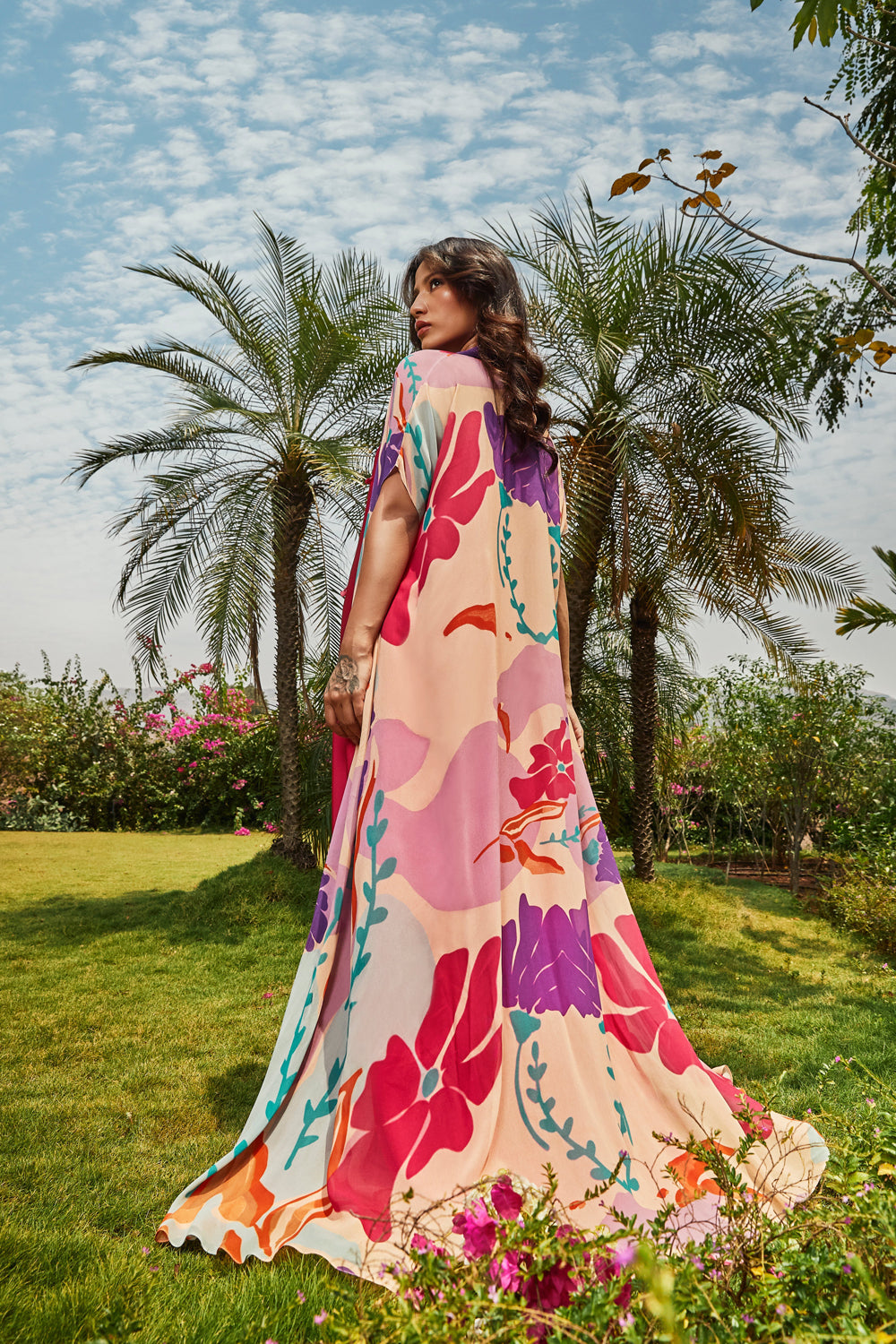 Foral printed cape paired with cerise pink bias dress.