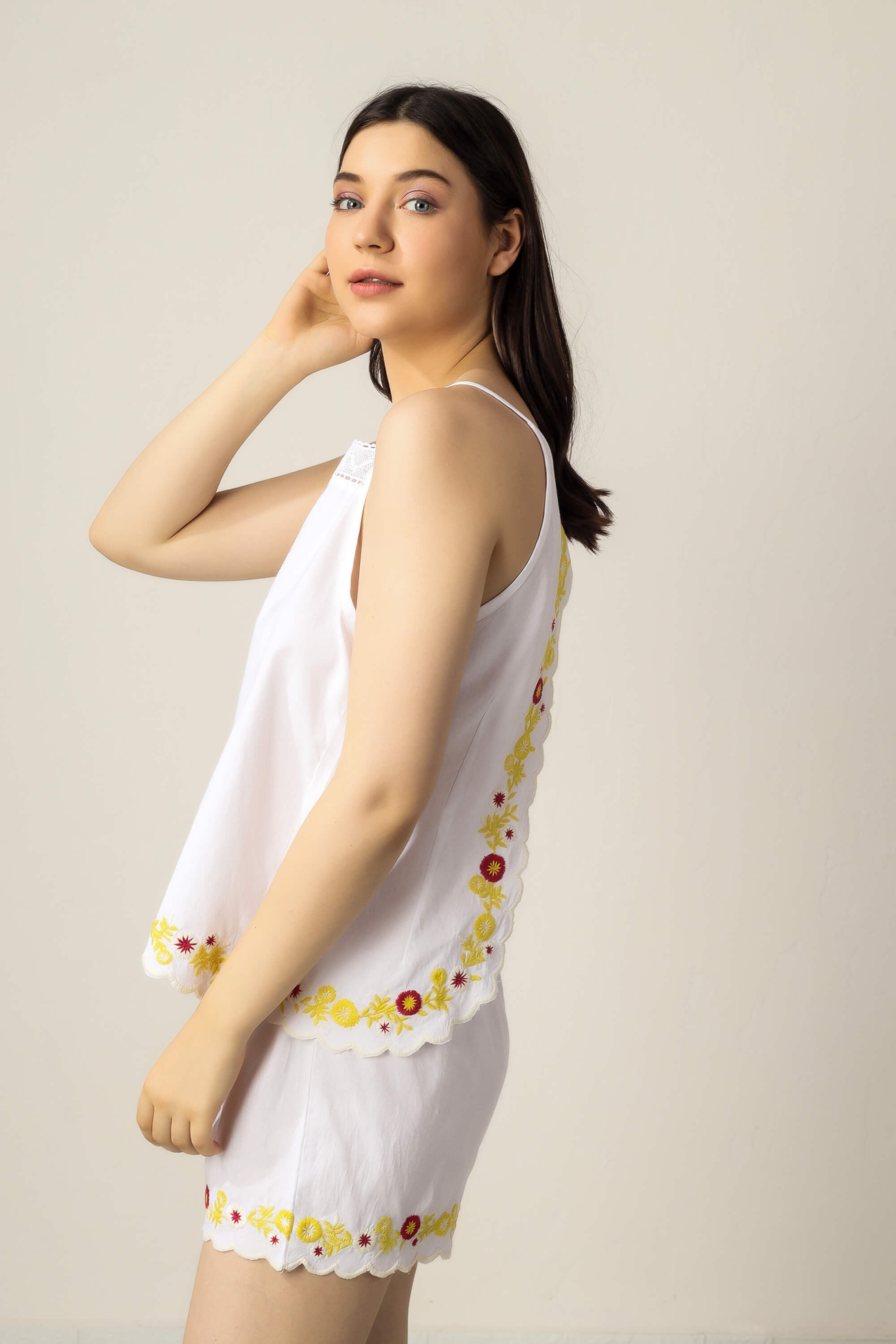 Model wearing Gwen shorts and camisole with floral embroidery.