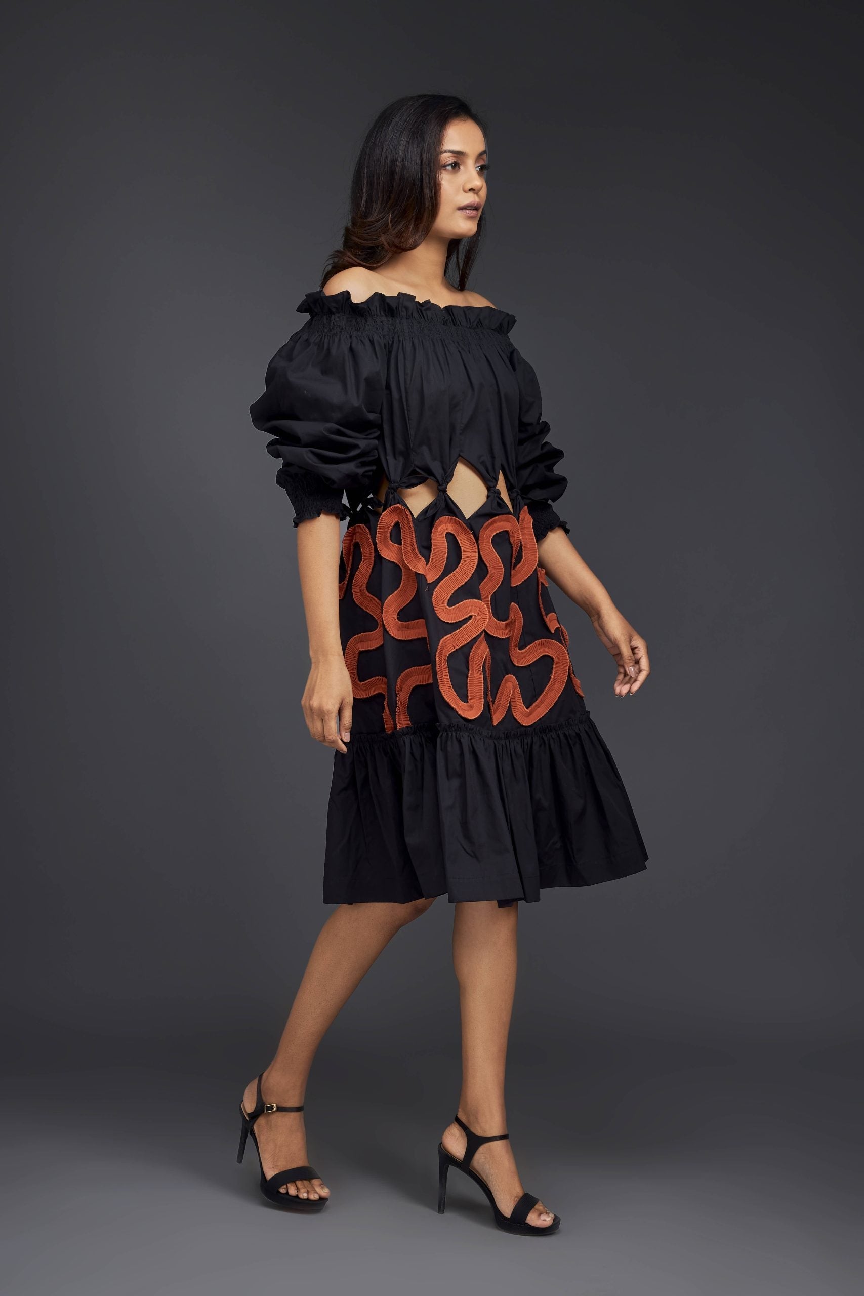 BLACK OFF-SHOULDER DRESS WITH WAIST CUTOUTS AND PLEATED FRILL DETAILING