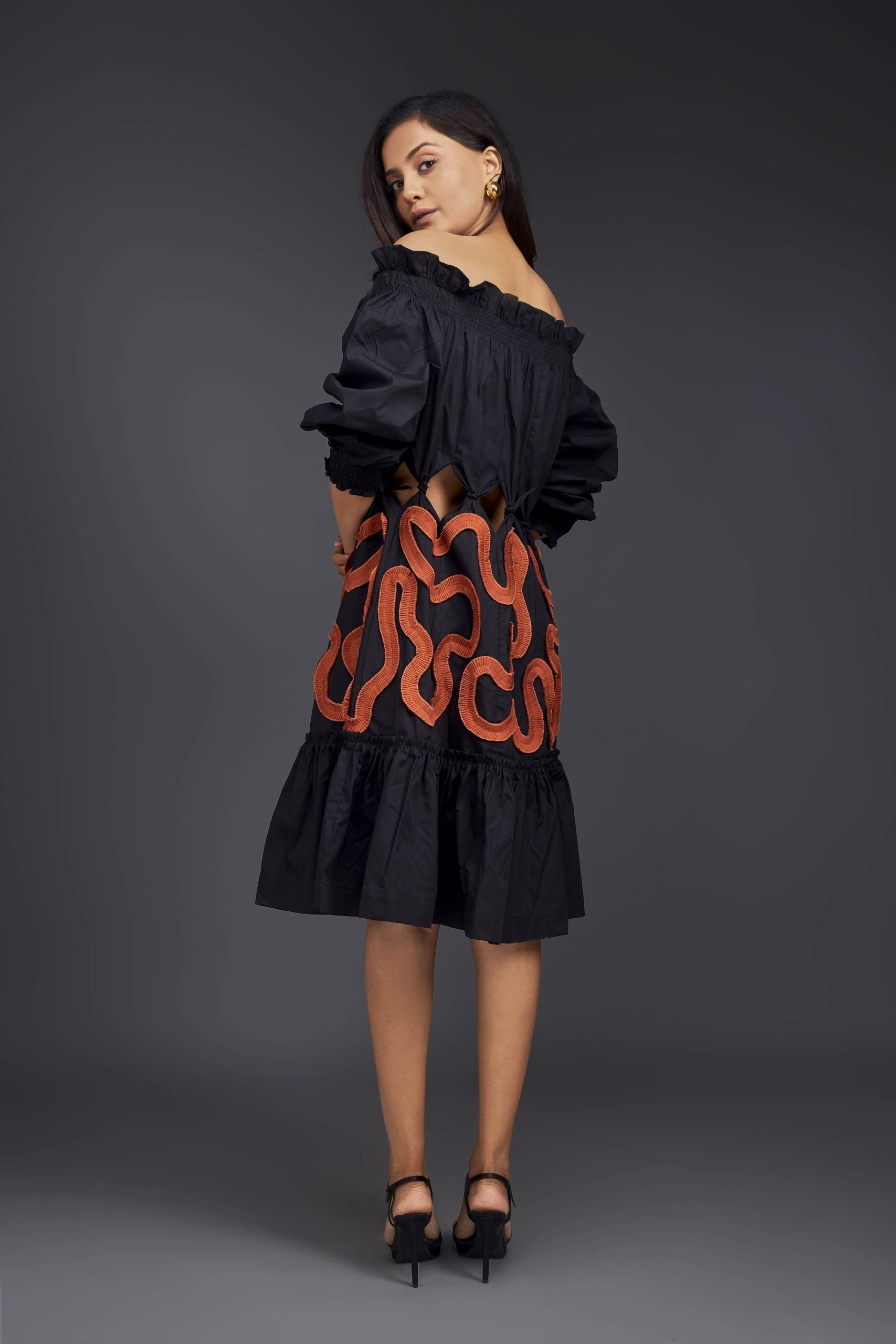 BLACK OFF-SHOULDER DRESS WITH WAIST CUTOUTS AND PLEATED FRILL DETAILING