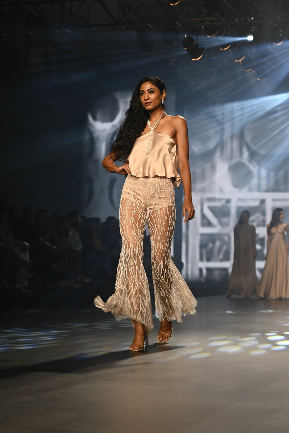 Taupe halter top with intricately embroidered flared pants.