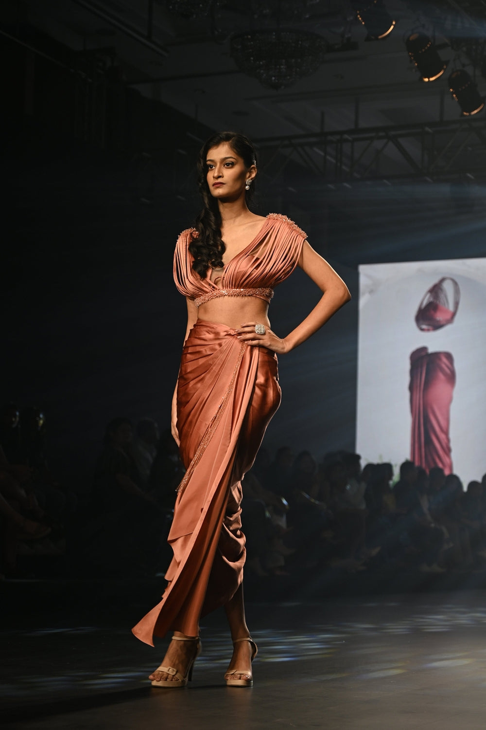 Nectarine draped skirt with a bralette and corded top with embellishments.