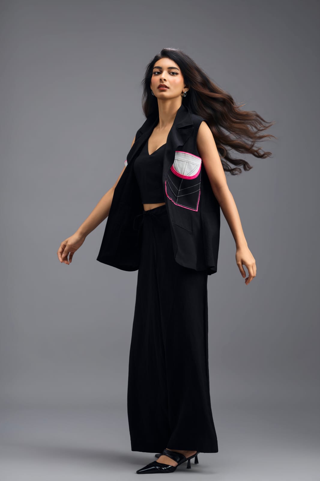 BLACK CO-ORD SET WITH NEON GEOMETRIC PANELLED SLEEVELESS BLAZER, TWISTED TOP AND TROUSERS