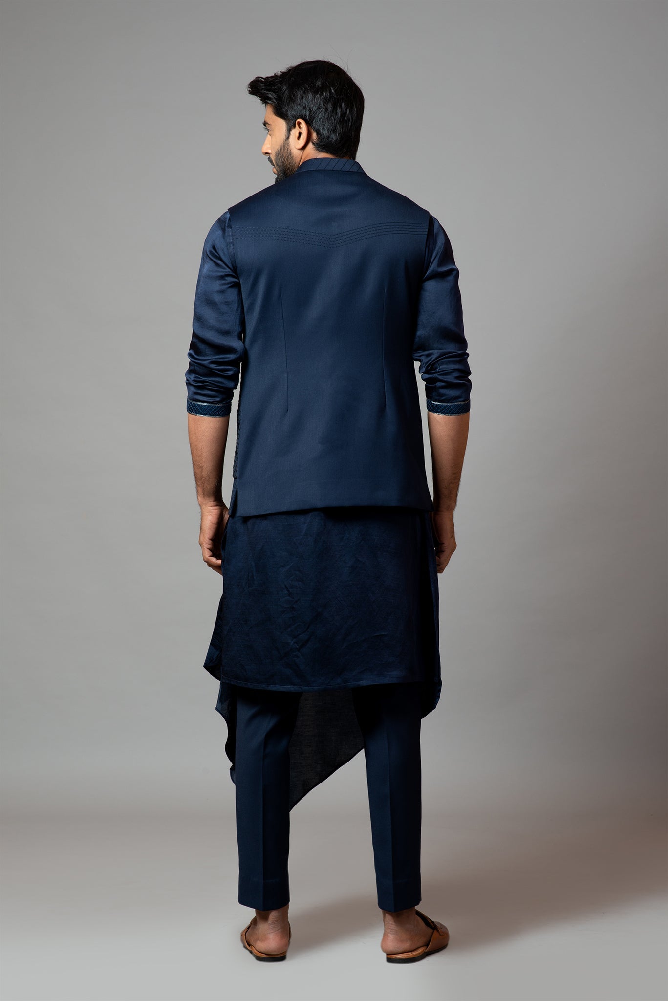 Navy blue Nehru jacket with Honeycomb pattern embroidery highlighted with panel detailing, paired with adrape kurta set